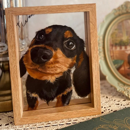 Custom hand-painted dog portrait on glass featuring a black and tan Dachshund puppy in a light wood frame.