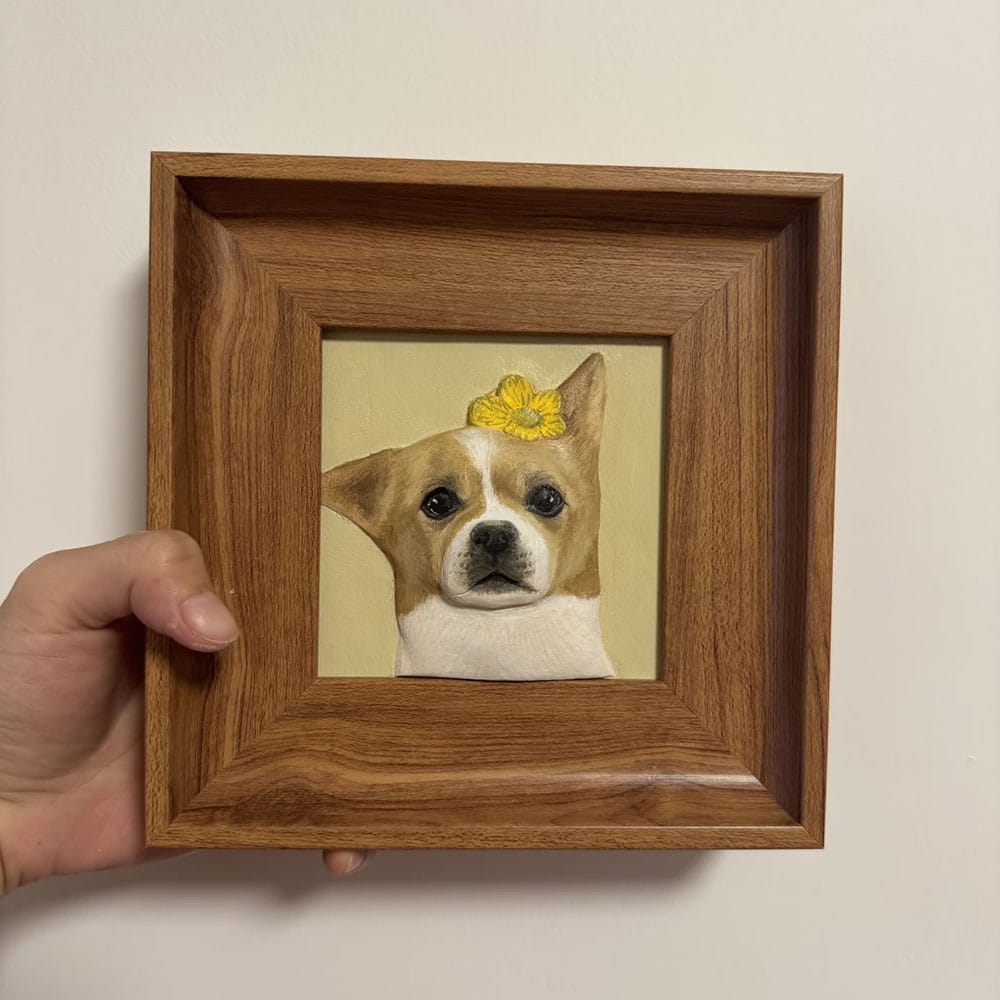 Custom pet portrait wood carving of a brown and white Chihuahua dog wearing a yellow flower, framed 3D relief art.