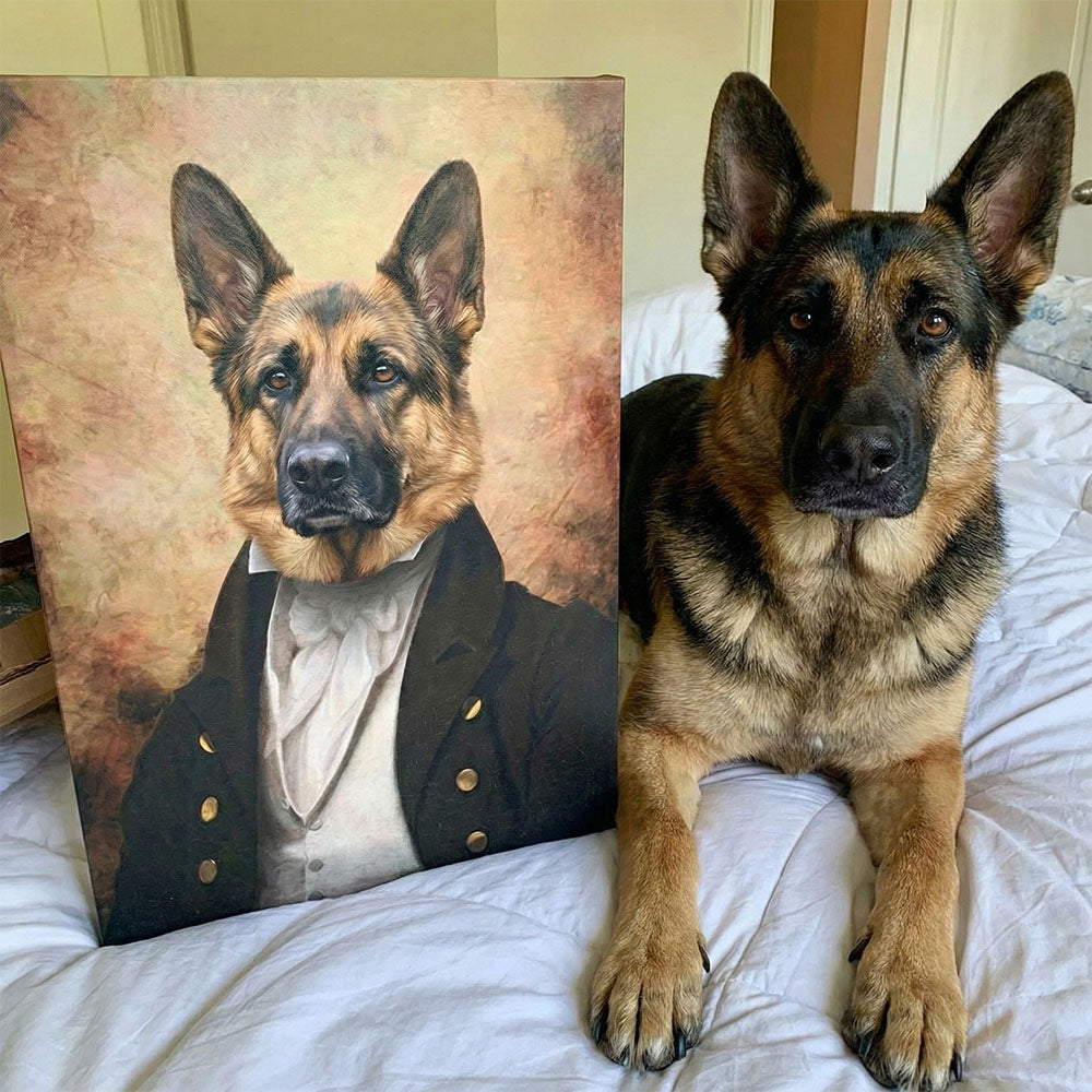 Dog sitting next to a portrait of itself dressed in formal attire on a bed.