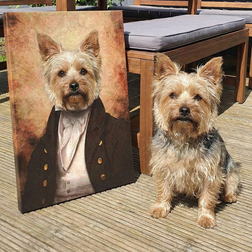 Dog sitting next to a portrait of itself dressed in formal attire on a wooden deck.