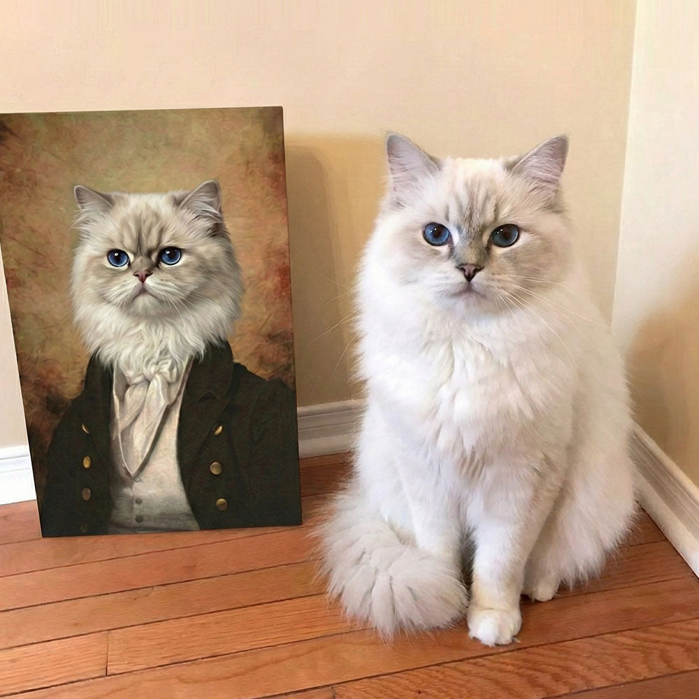 Real cat sitting next to a portrait of a cat dressed in formal attire on a wooden floor.