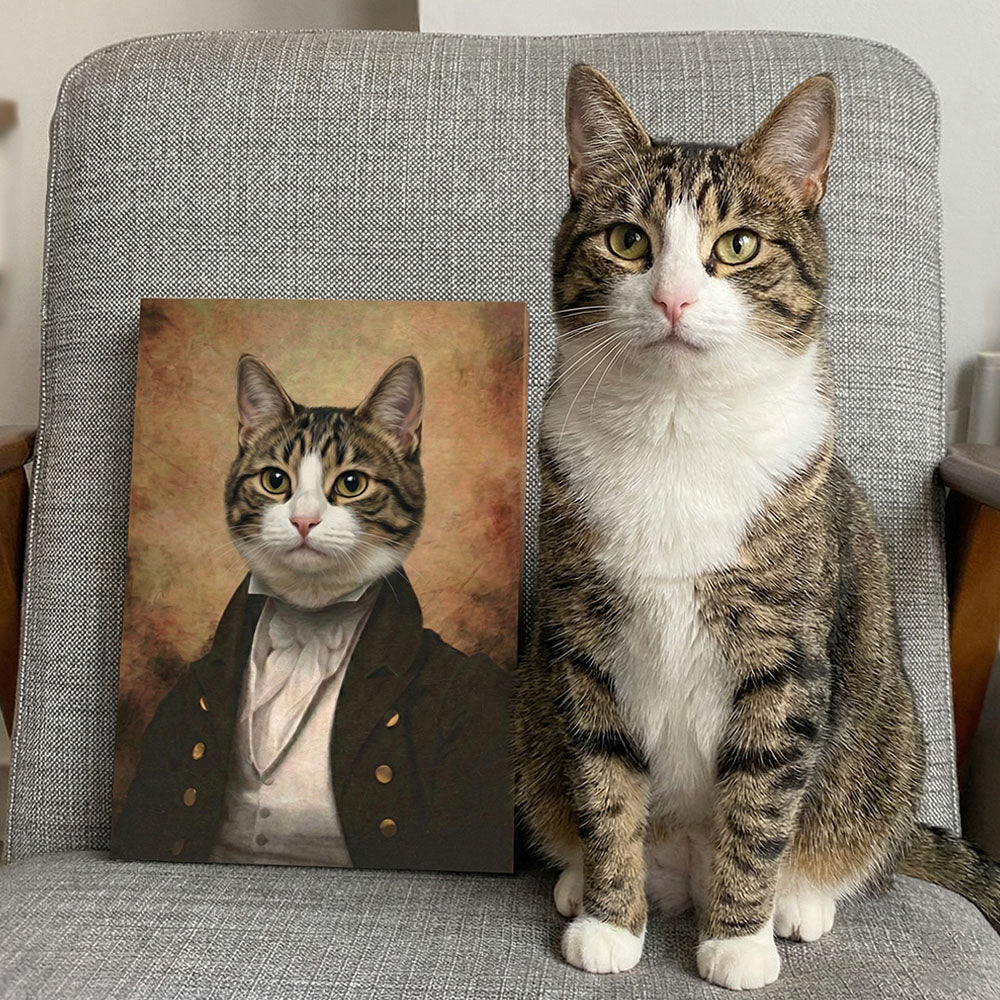 Cat sitting on a chair next to a portrait of itself in formal attire.