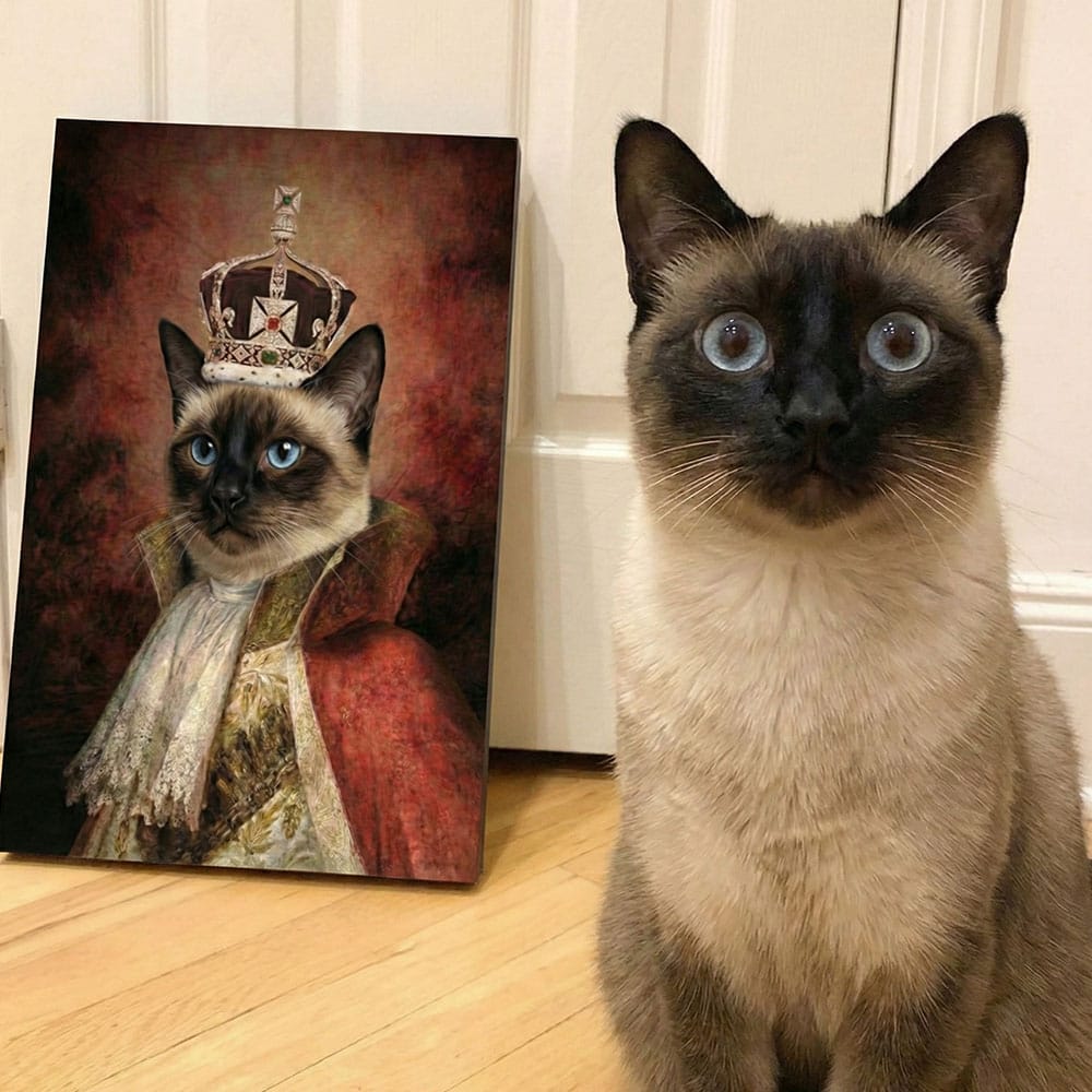 Real cat sitting next to a painting of a cat wearing a crown on a wooden floor.