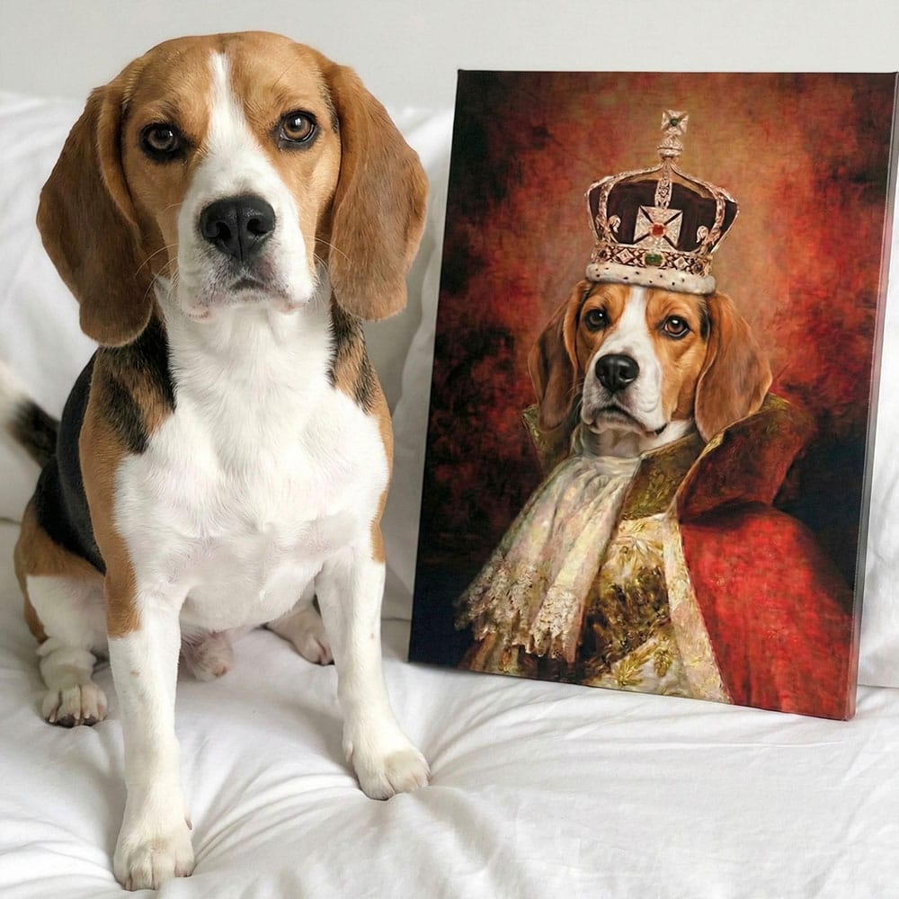 Real dog next to a painting of a dog wearing royal attire on a white surface