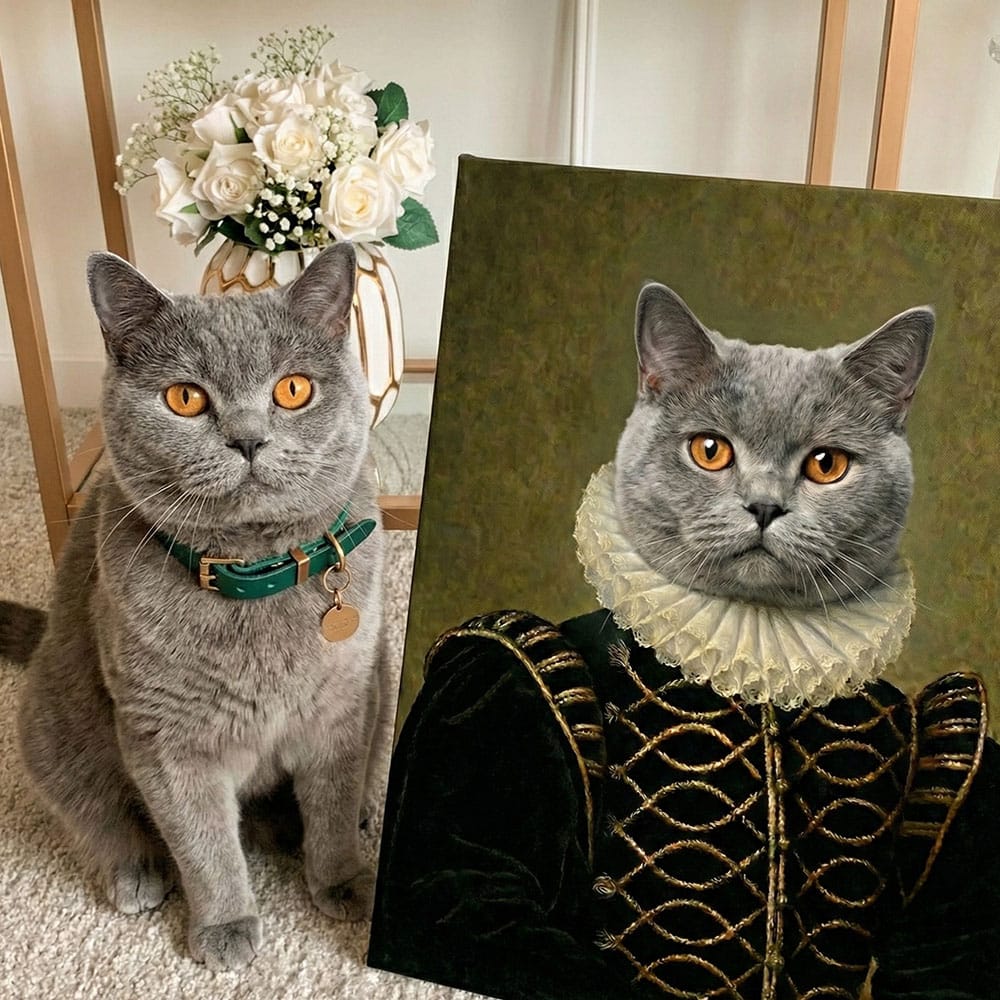 Real cat next to a painting of itself dressed in historical attire