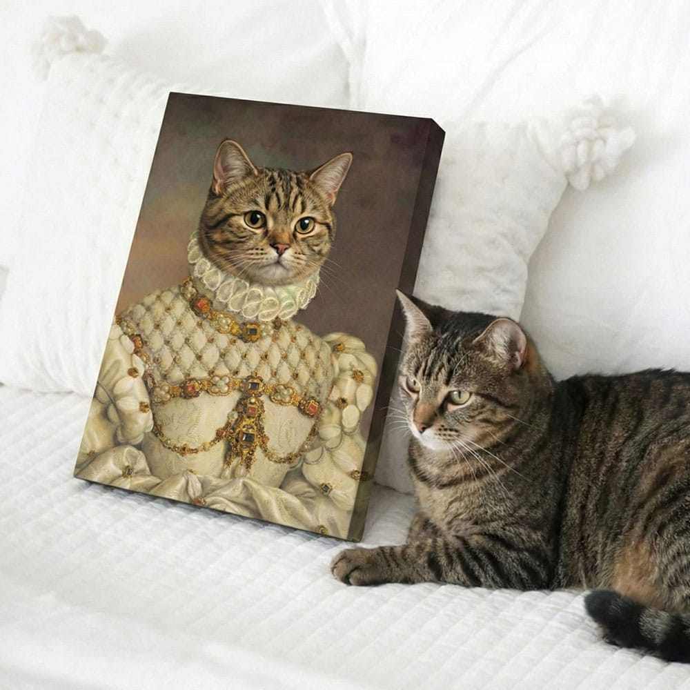 Cat sitting next to a painting of itself in regal attire on a white surface.