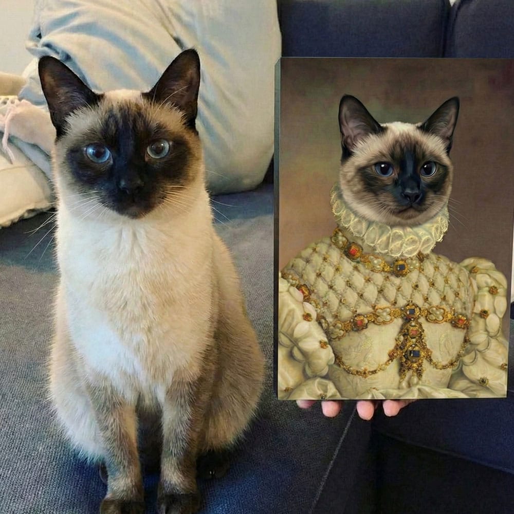 Siamese cat sitting on a couch next to a painting of a Siamese cat in regal attire.