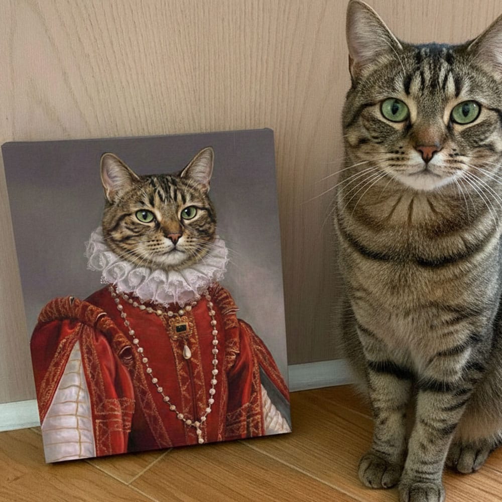 Cat next to a painting of itself in regal attire on a wooden floor.