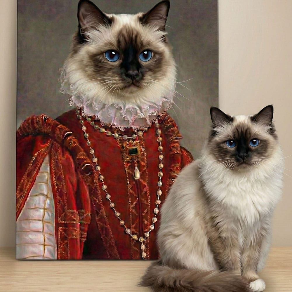 Cat dressed in regal attire next to a real cat on a wooden surface