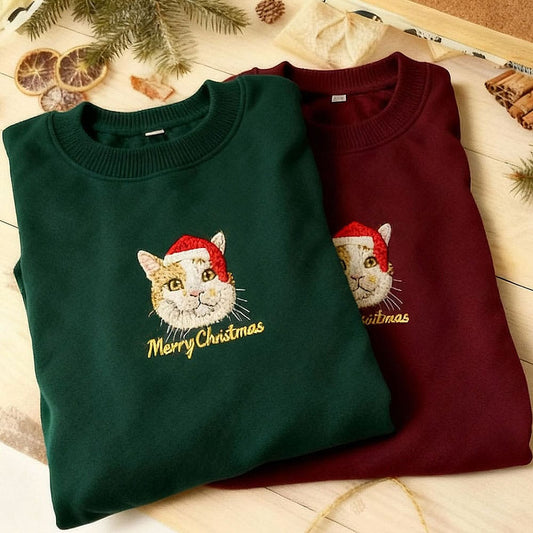 Green and red custom embroidered pet portrait Christmas sweatshirt featuring a cat wearing a Santa hat.