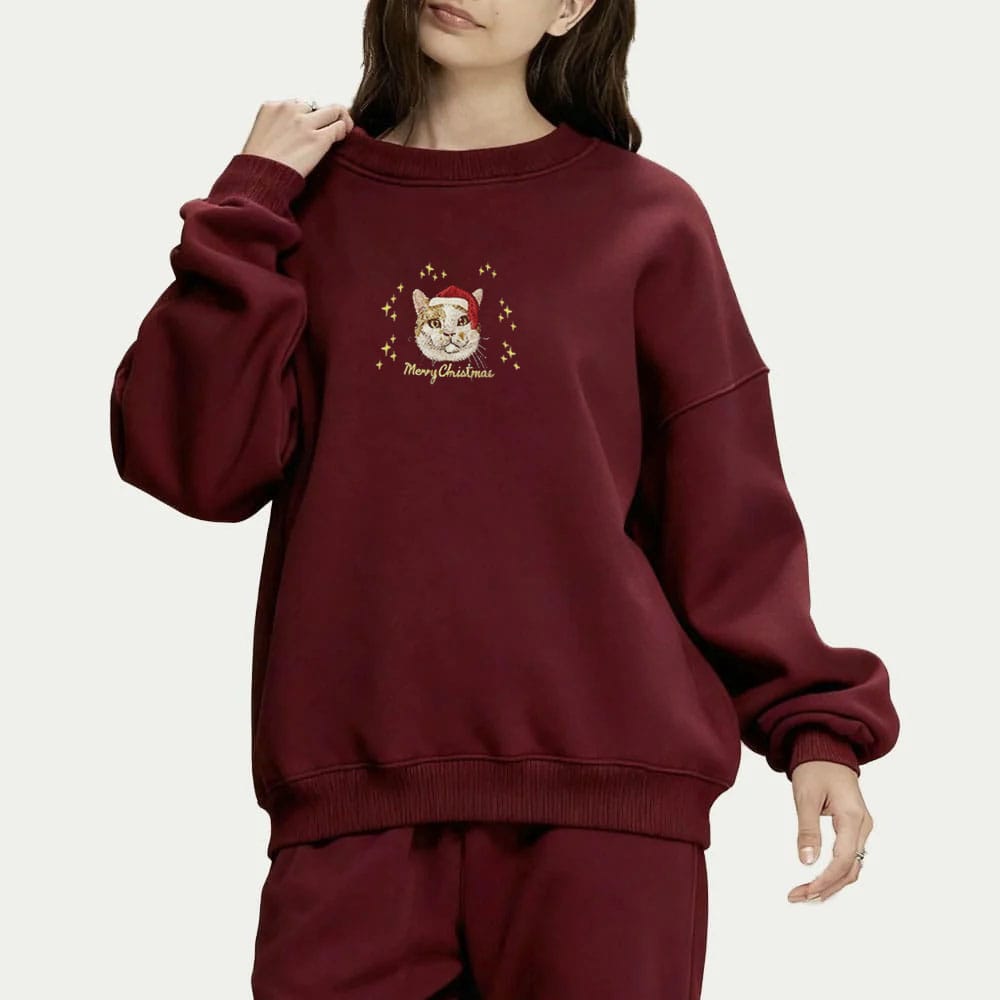 Red custom embroidered pet portrait Christmas sweatshirt featuring a cat wearing a Santa hat.
