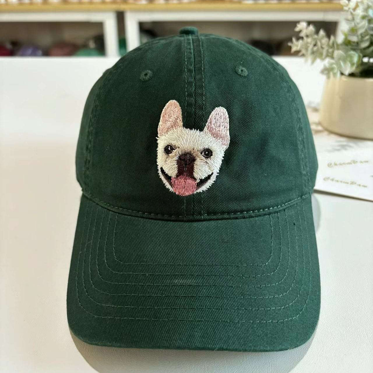 A custom embroidered hat featuring a detailed pet portrait.
