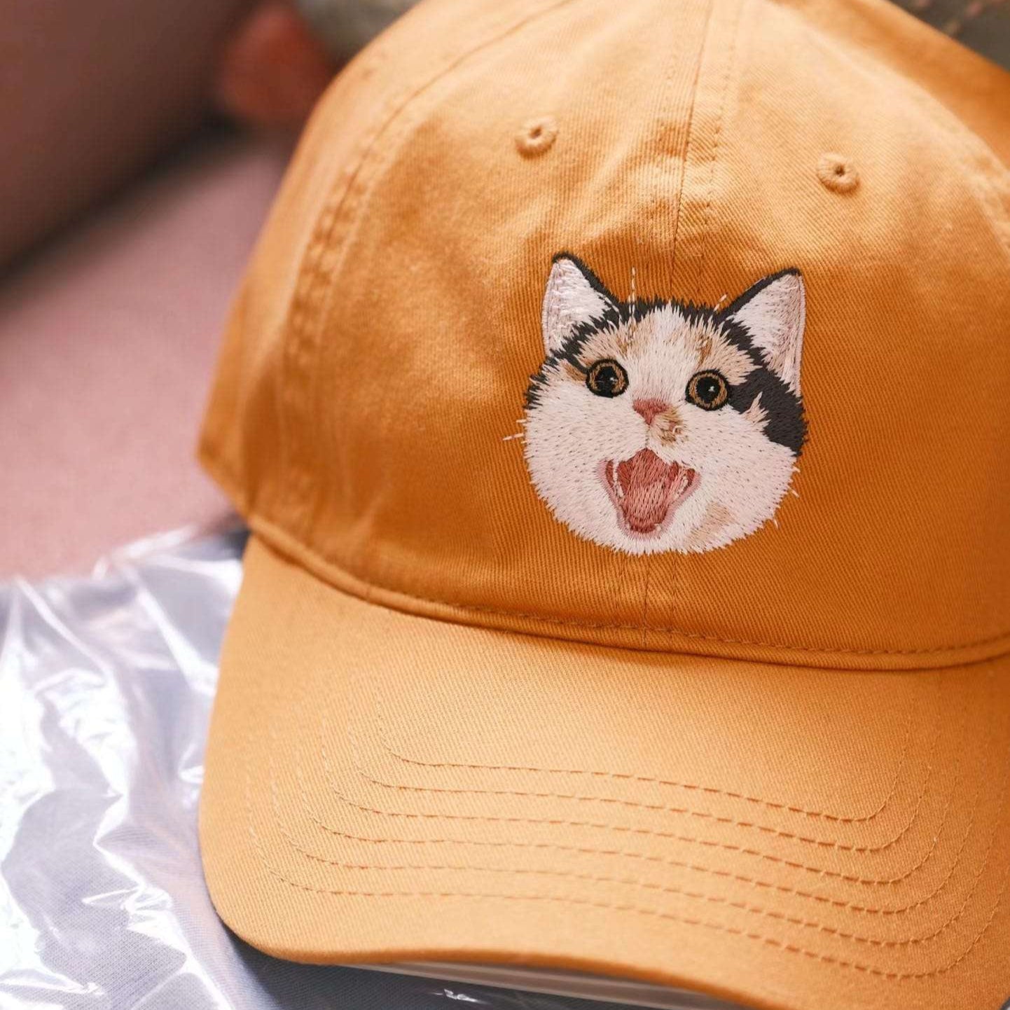 A custom embroidered hat featuring a detailed pet portrait.
