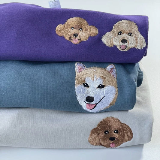 A custom embroidered pet portrait hoodie featuring a detailed portrait of a pet.