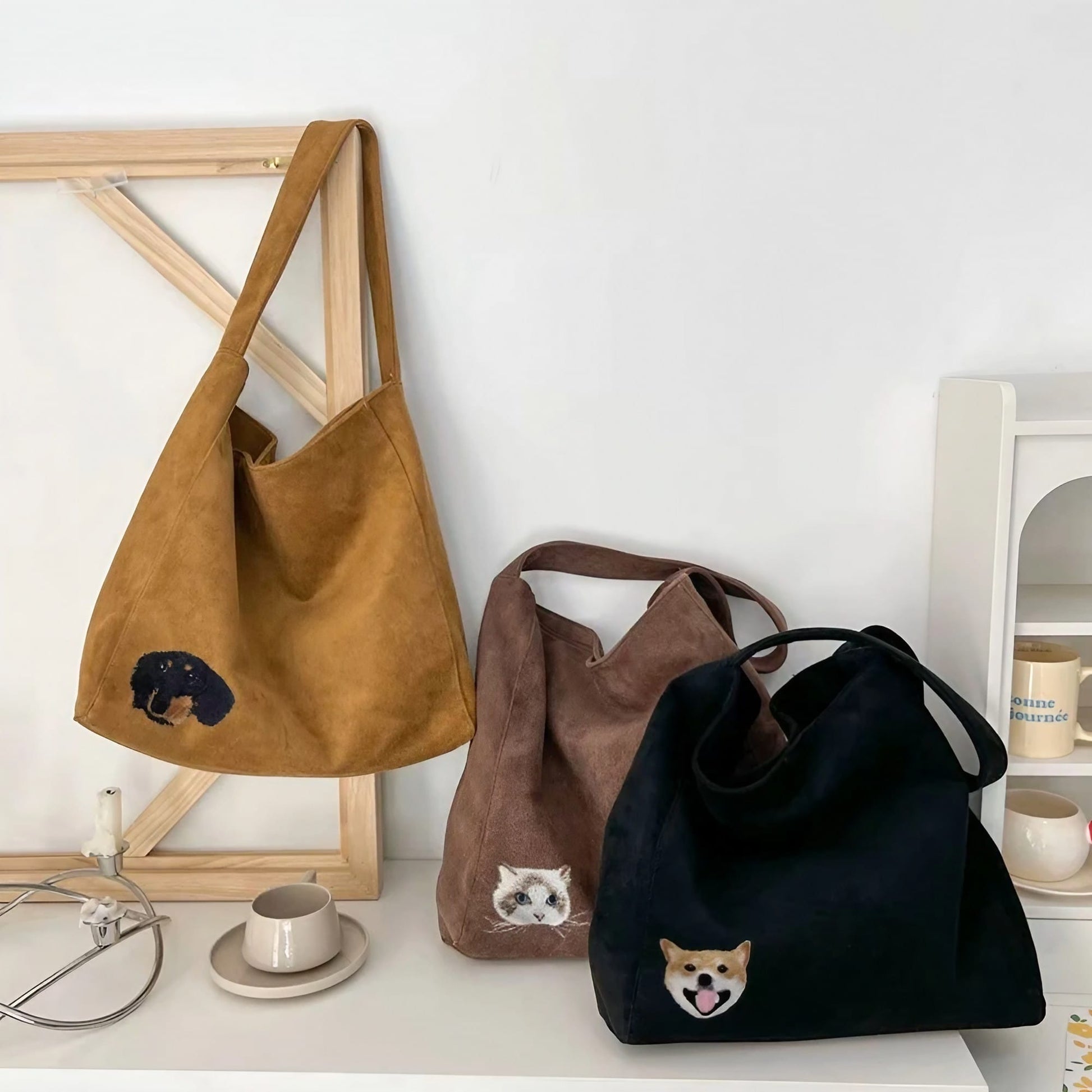 A custom embroidered pet portrait on a stylish suede tote bag.