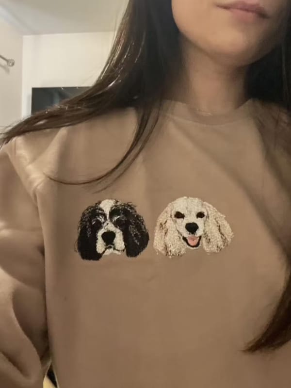 A custom sweatshirt featuring a detailed embroidered pet portrait.