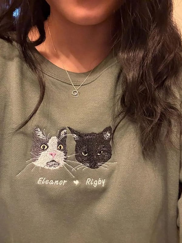 A custom sweatshirt featuring a detailed embroidered pet portrait.