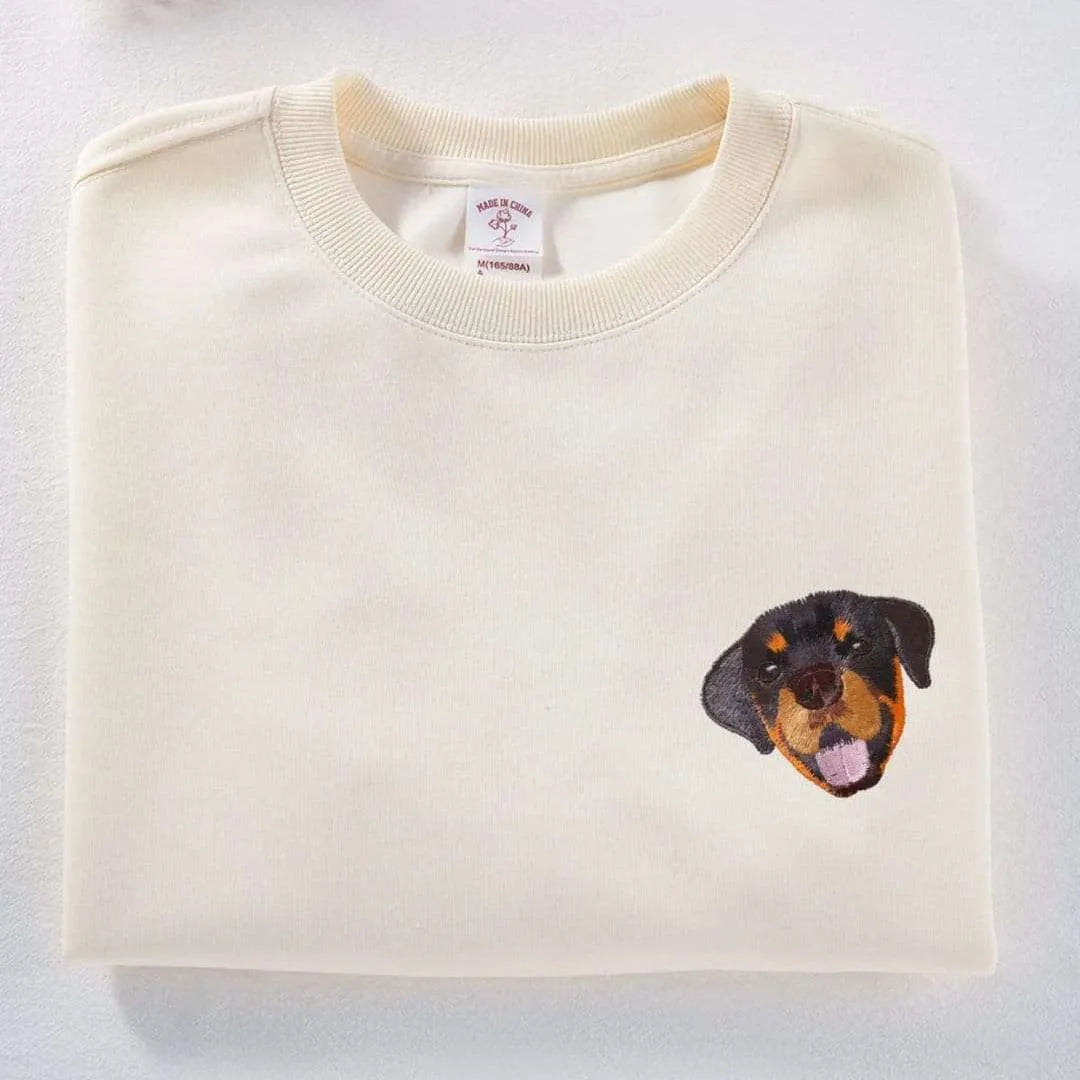 A custom sweatshirt featuring a detailed embroidered pet portrait.