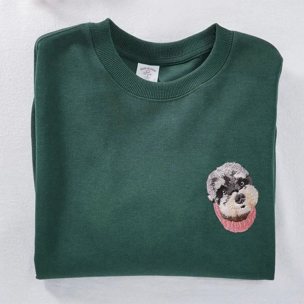 A custom sweatshirt featuring a detailed embroidered pet portrait.