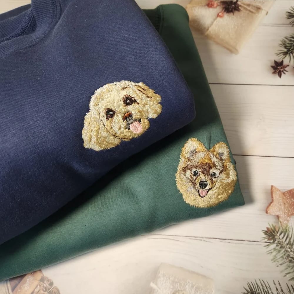 A navy custom sweatshirt featuring a detailed embroidered pet portrait.