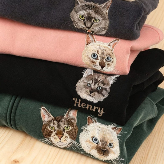 A custom embroidered pet portrait sweatshirt featuring a detailed portrait of a pet.