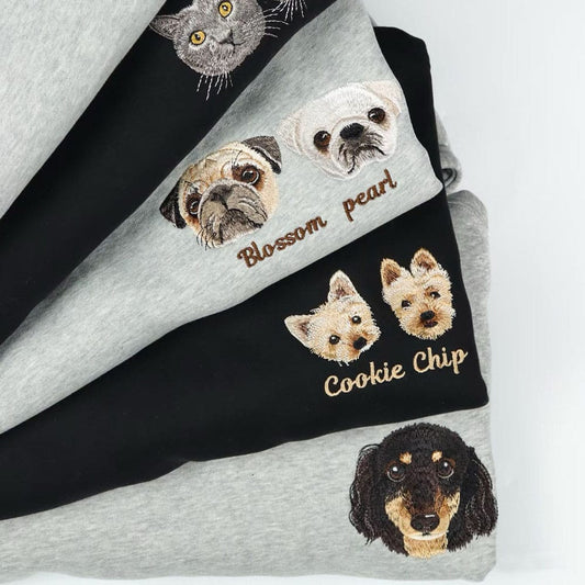 Embroidered sweatshirts with dog and cat faces on a white background