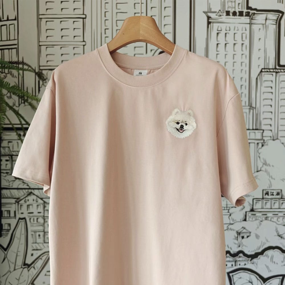 A custom t-shirt featuring a detailed embroidered pet portrait.