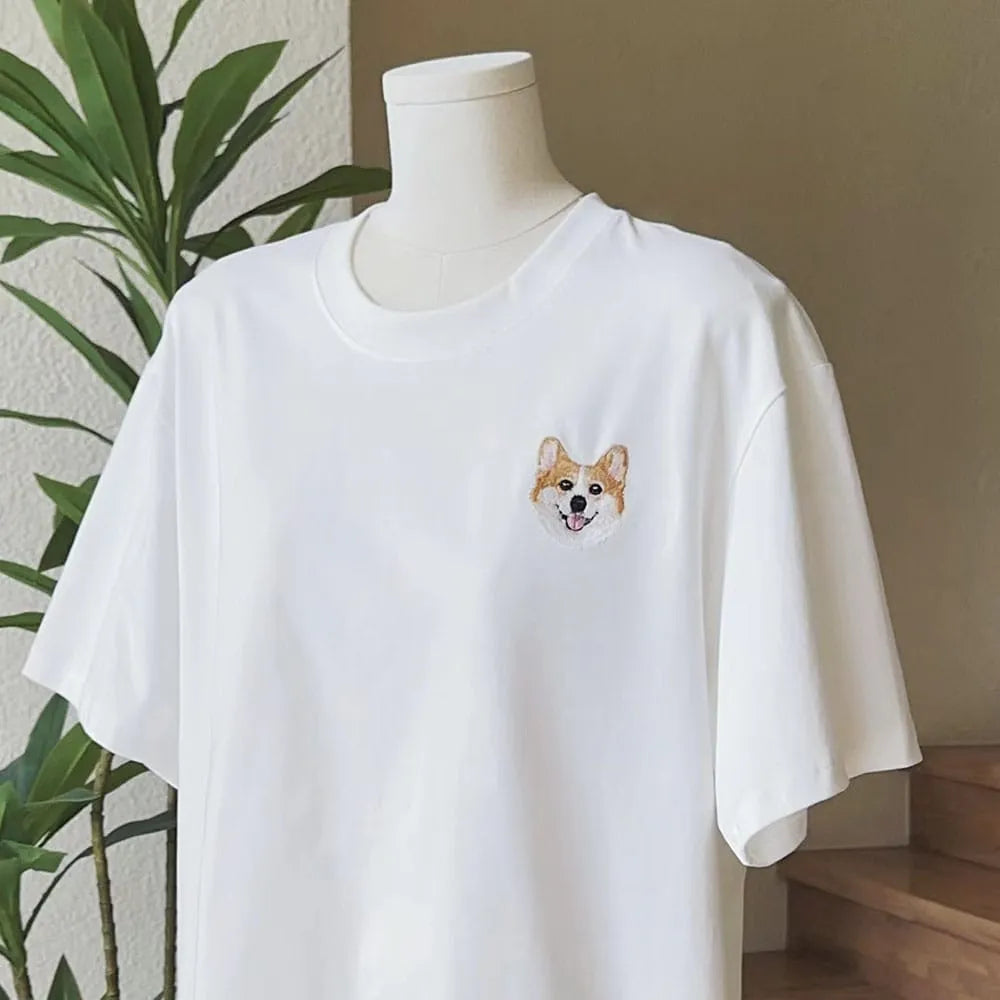 A custom t-shirt featuring a detailed embroidered pet portrait.