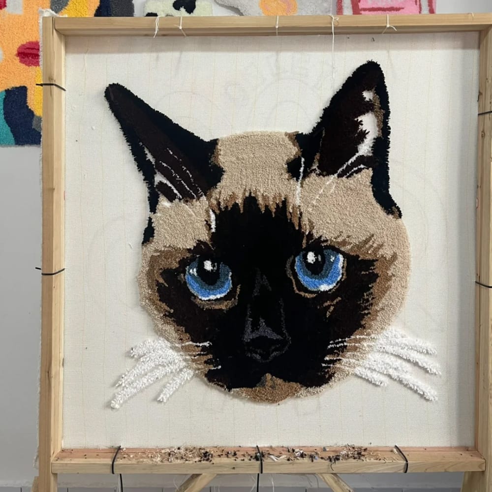 A handmade custom tufted rug designed to look like a pet's portrait.