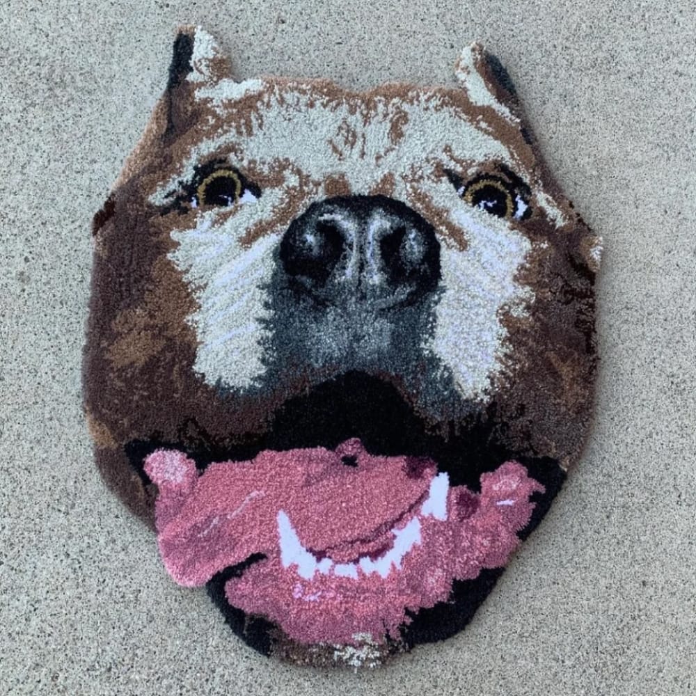 A handmade custom tufted rug designed to look like a pet's portrait.