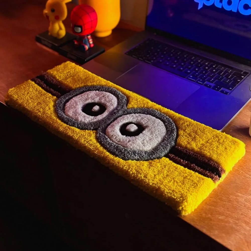 Close-up of custom tufted keyboard mats featuring colorful cartoon character designs.