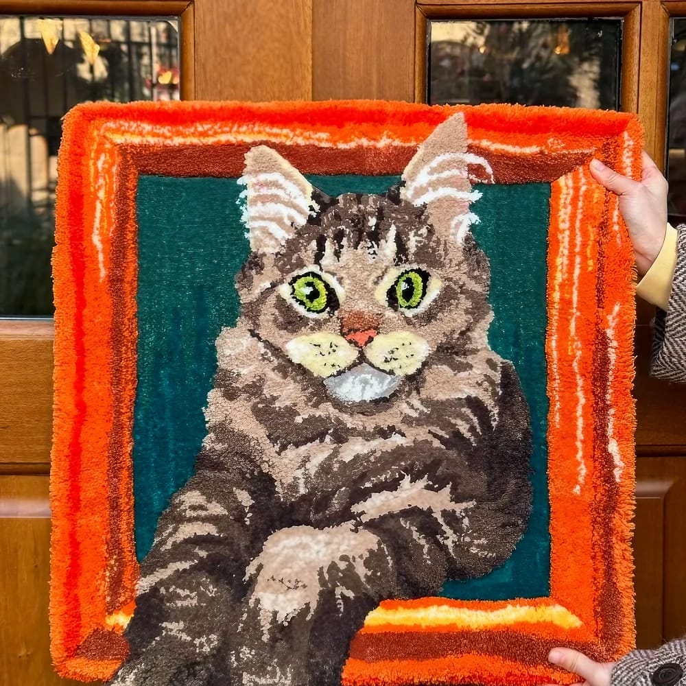A handmade custom tufted pet tapestry featuring a detailed portrait of a pet.