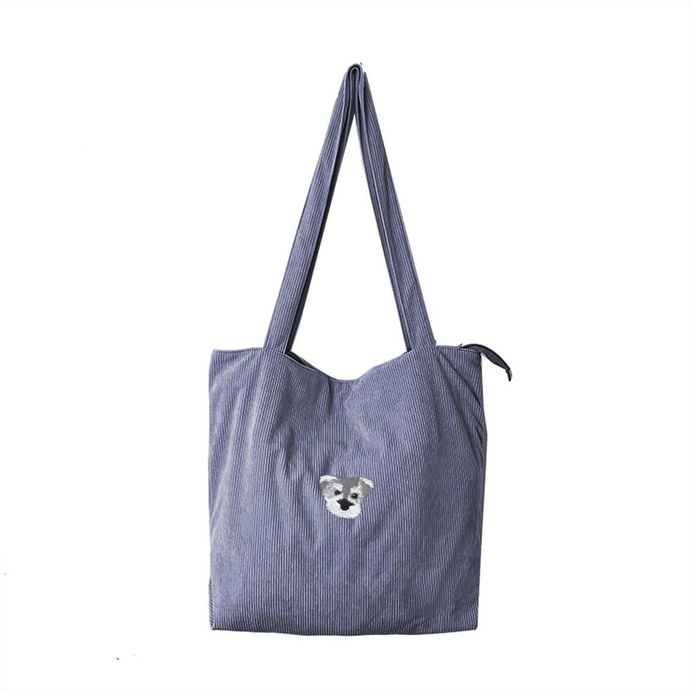 A blue gary corduroy bag featuring a custom embroidered pet portrait.