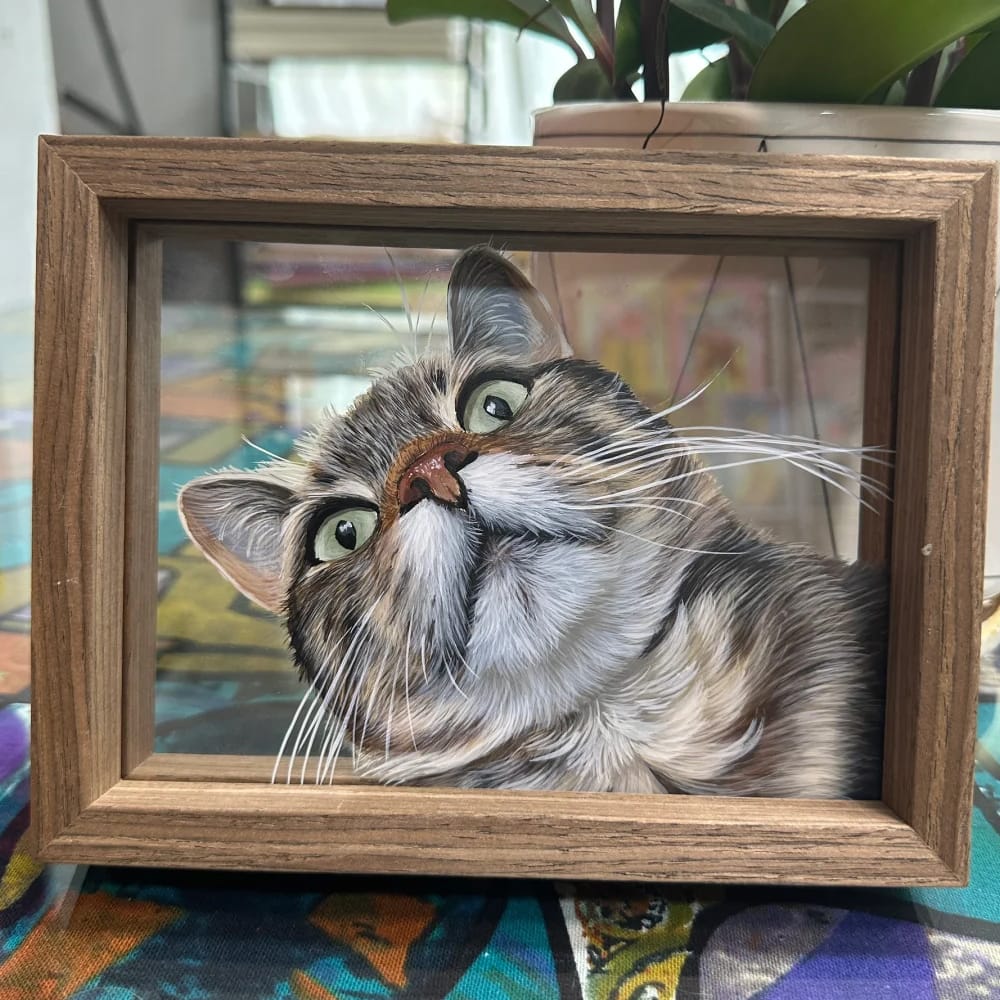 Personalized pet portrait on single-layer glass featuring a hand-painting of a tabby cat looking up.